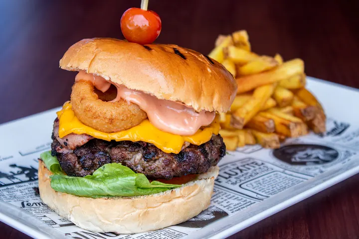 Loaded burger and chips at Flame Grill